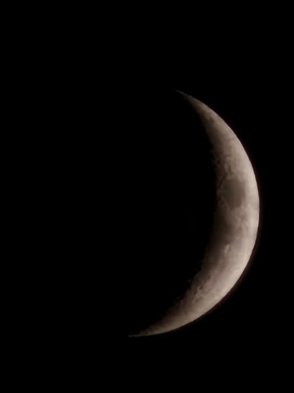 Crescent moon rising over Esch-sur-Alzette at dusk