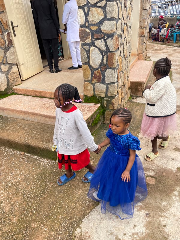 Morning activity outside a stone building in Jos, Nigeria