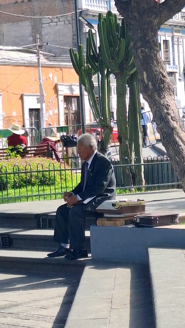 Elderly man bows in Arequipa's Plaza de Armas