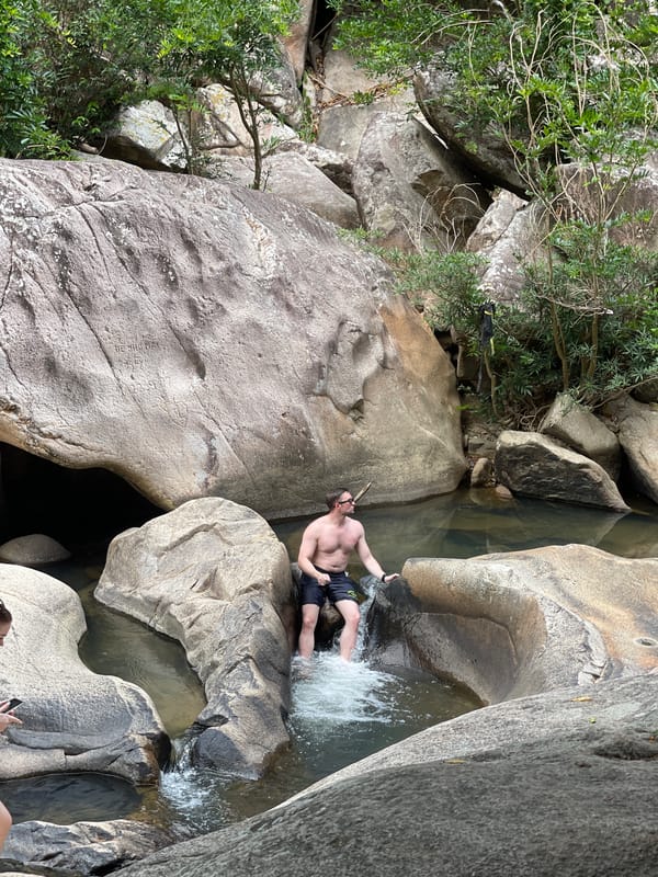 Man wades among boulders at Vietnamese rocky coast