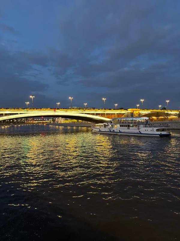 Passenger boat cruises the Moscow River at dusk