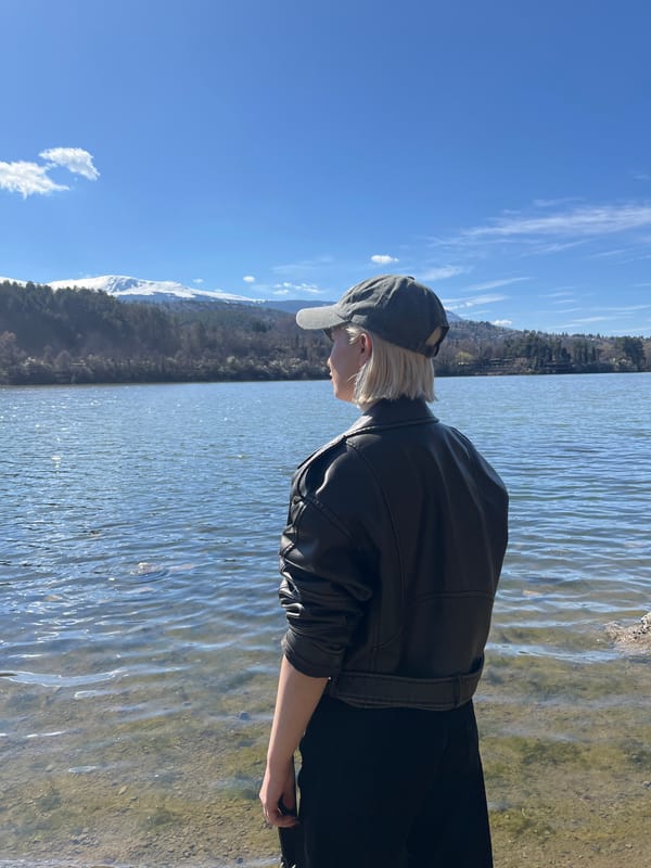Person in leather jacket visits Lake Pancharevo on sunny day