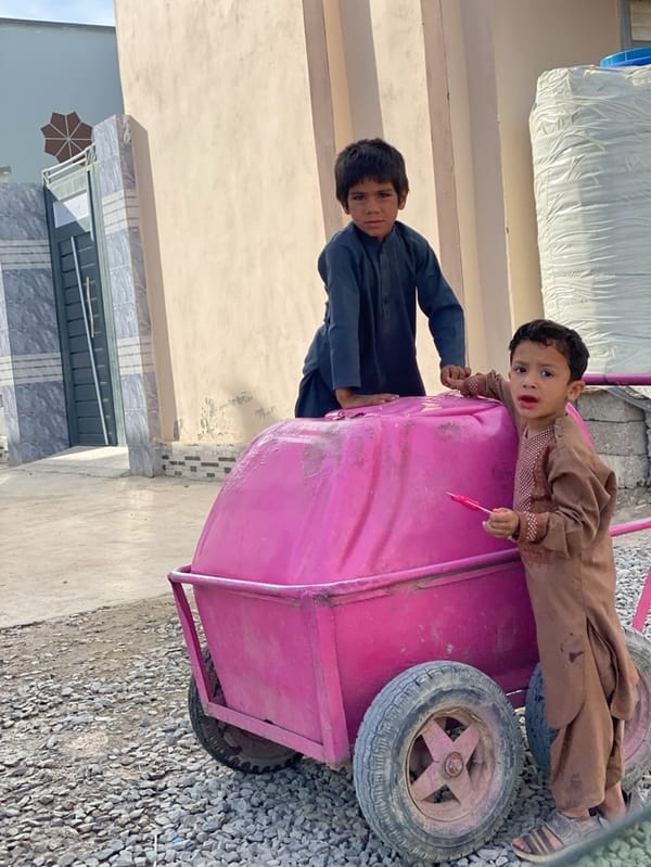 Boys play with pink cart on Kandahar street
