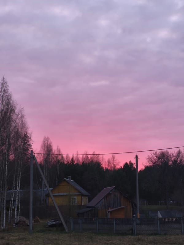Sunset colors illuminate rural Belarus landscape near Парэчча