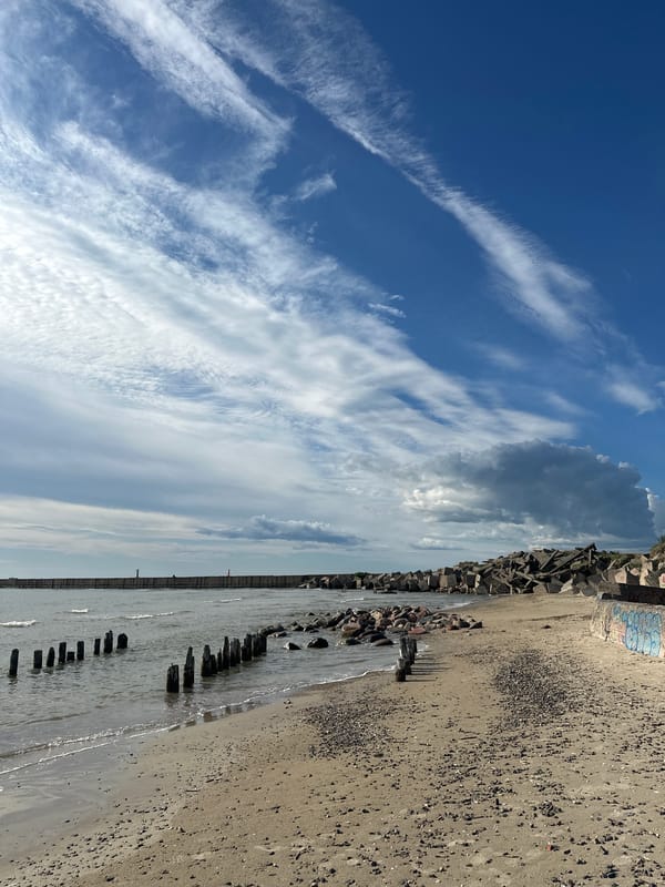 Liepāja's weathered Baltic coast — beach, barriers, and port edges