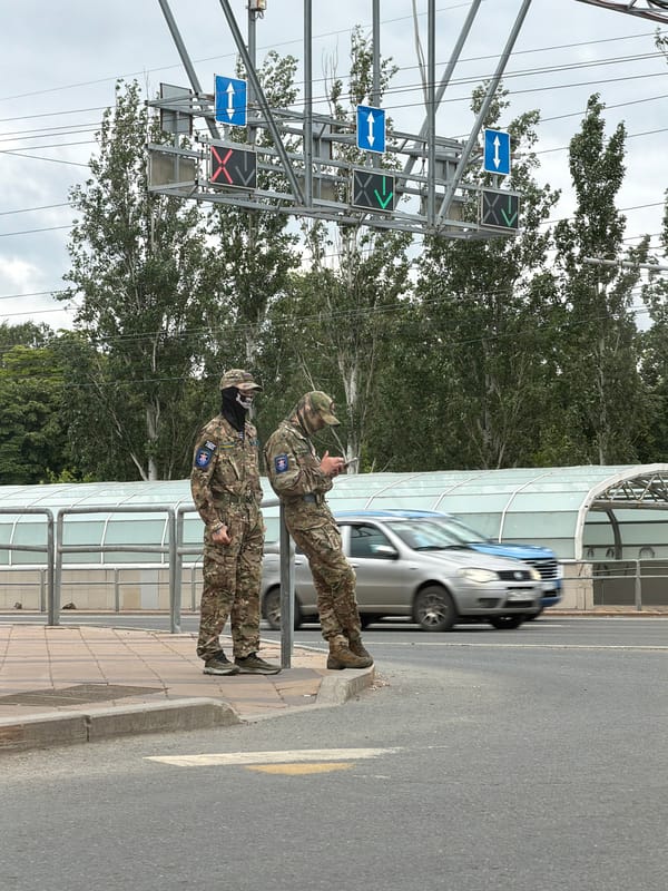 Two camouflaged men observed on Samara sidewalk
