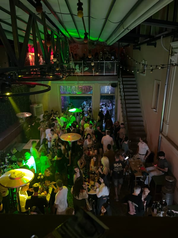 Crowded urban bar hosts lively evening social gathering