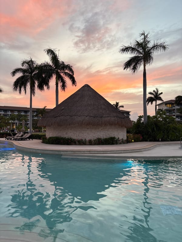 Sunset poolside at a Punta Sam resort, Delphinus Maroma
