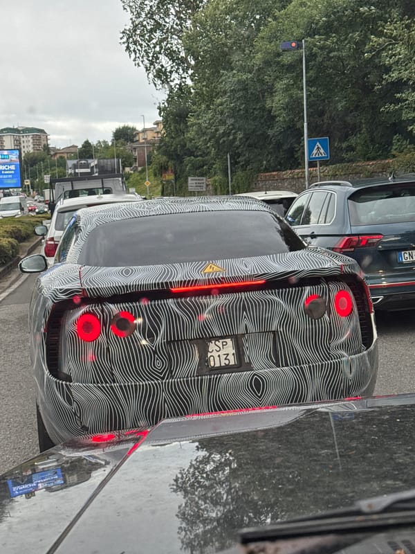 Black patterned car with brake lights on, Lipomo street.