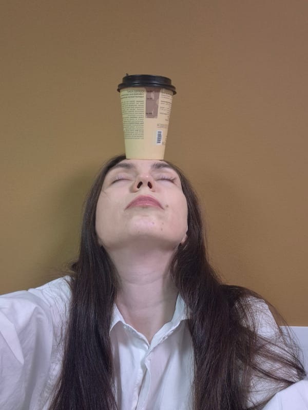 Woman plays with coffee cup in early morning moment