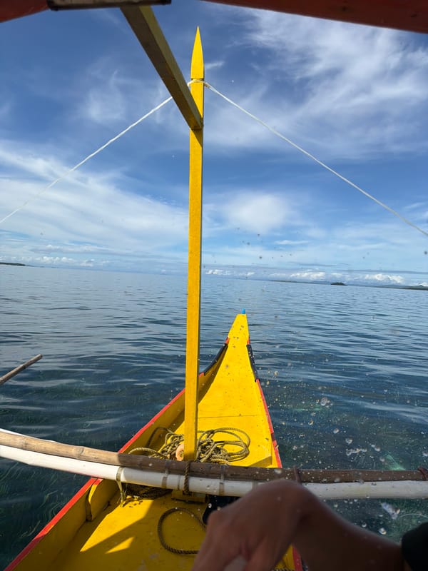 Woman applies sunscreen during outrigger boat ride in Philippines