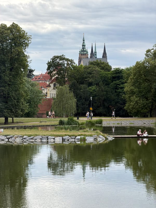 Park fountains and Vltava River views near Prague Castle