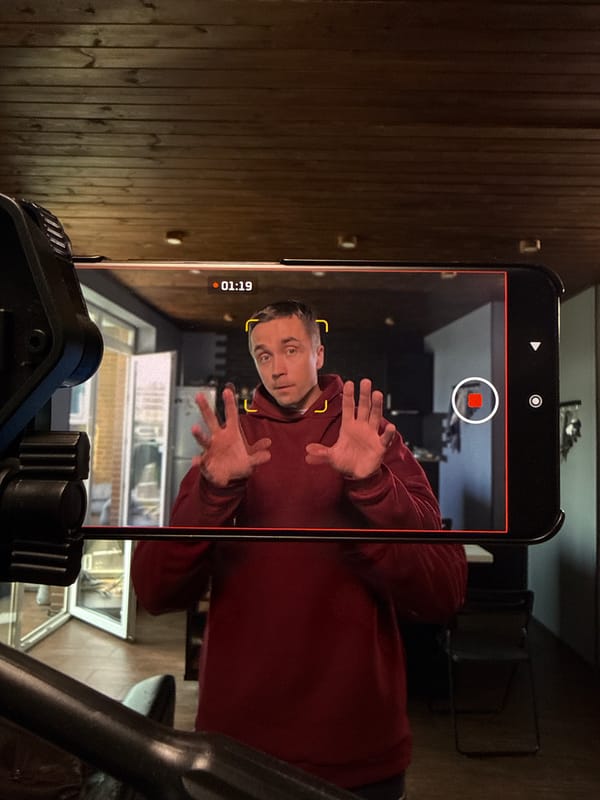 Man in red hoodie filmed with hands raised in Moscow