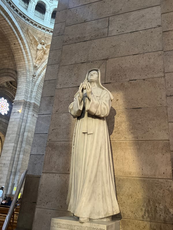 Visitor documents Sacré-Cœur Basilica interior architecture and religious artifacts
