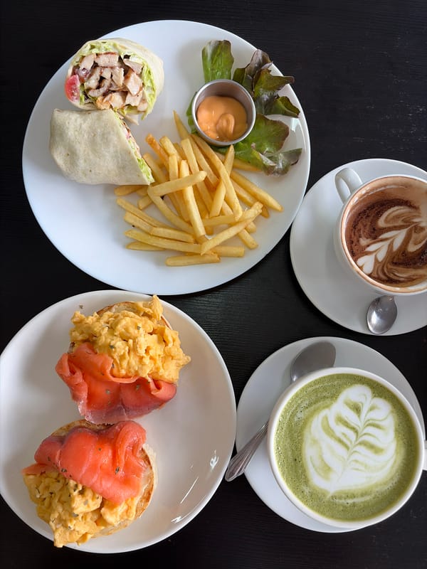 Coffee, food, and elephant figurines at a Bangkok café