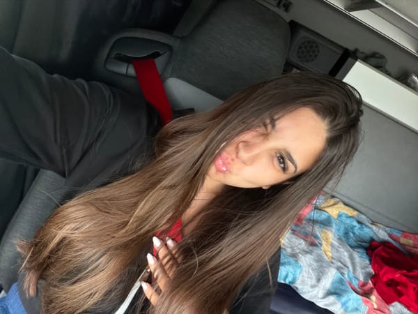 Selfie and road view from inside a vehicle on a highway