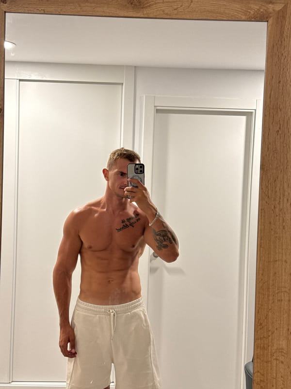 Post-workout mirror shots in Finestrat, boxing tattoo on display