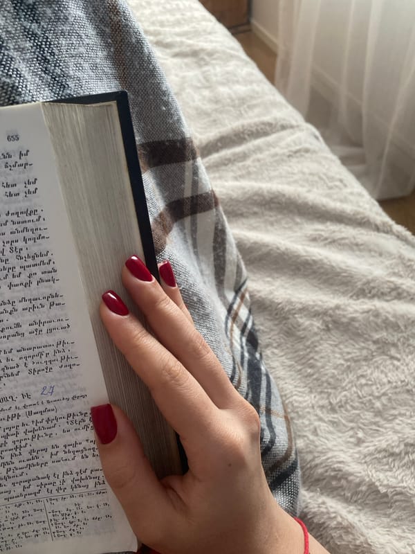 Quiet reading moment with Armenian book and tea in Sweden