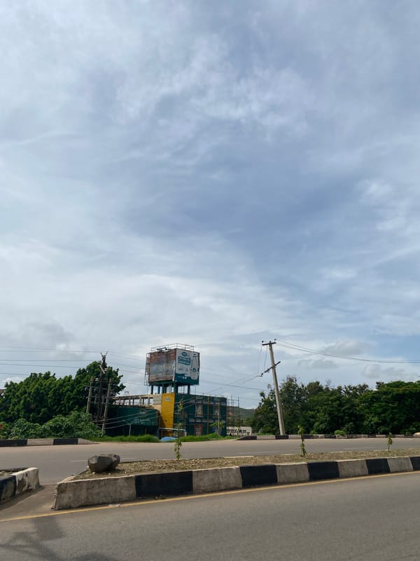 Morning traffic and street scenes along a Jos city road