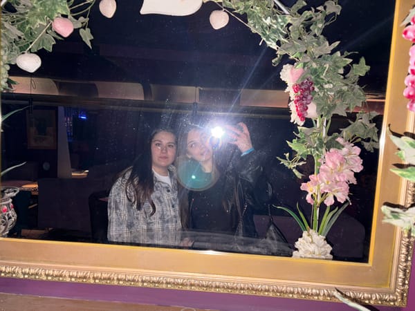 Two women captured in mirror reflection in Izhevsk