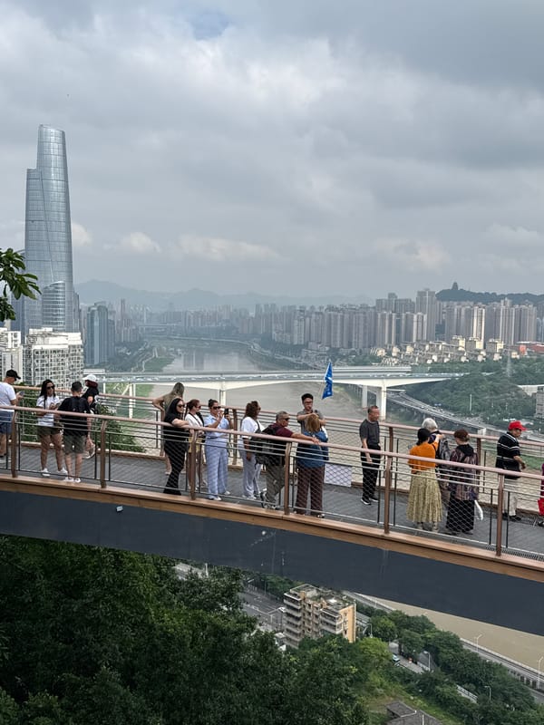 Late-night gathering on pedestrian bridge overlooks Yuzhong District skyline