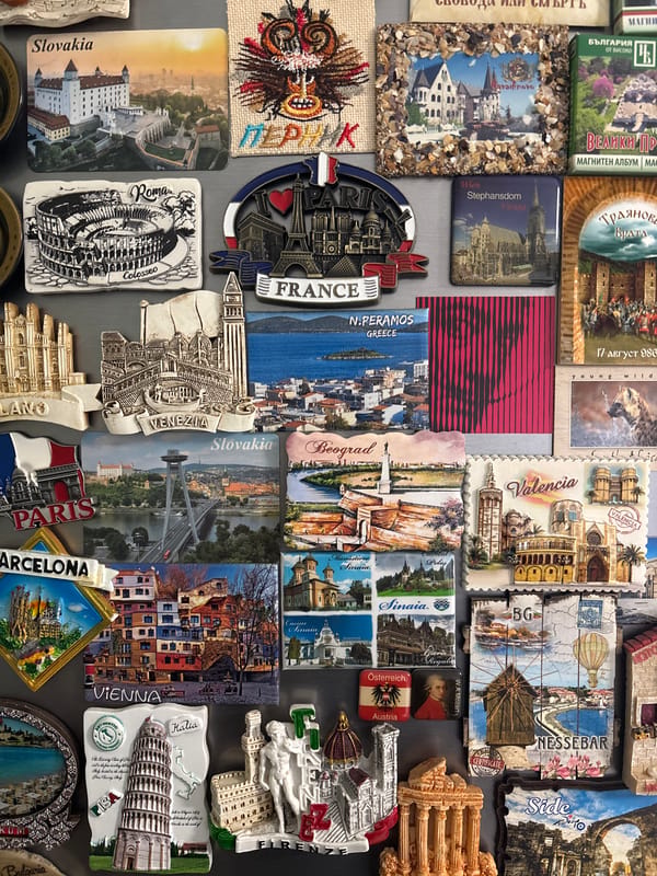 International souvenir magnet collection photographed on gray surface