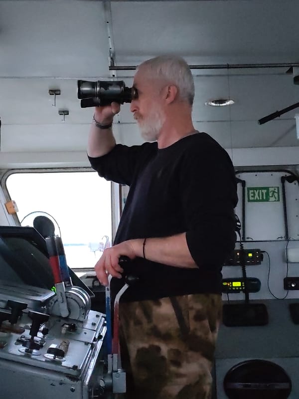Ship crew navigates choppy waters during nighttime voyage