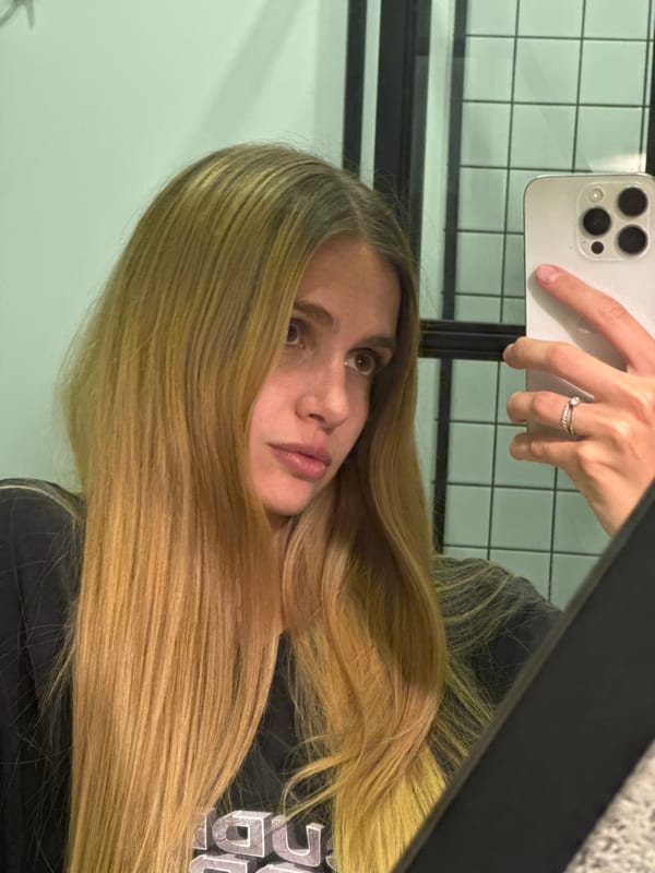 Woman takes bathroom mirror selfie in Tbilisi