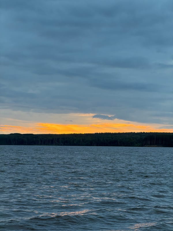 Man photographed during twilight fishing scene in Chaikovsky, Russia