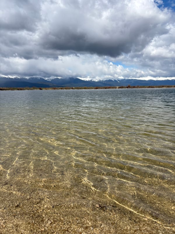 Person enjoys lakeside relaxation near Bansko mountain lake
