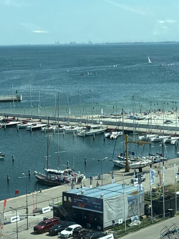 Gdynia marina buzzes with sailboats, a tall ship, and waterfront construction