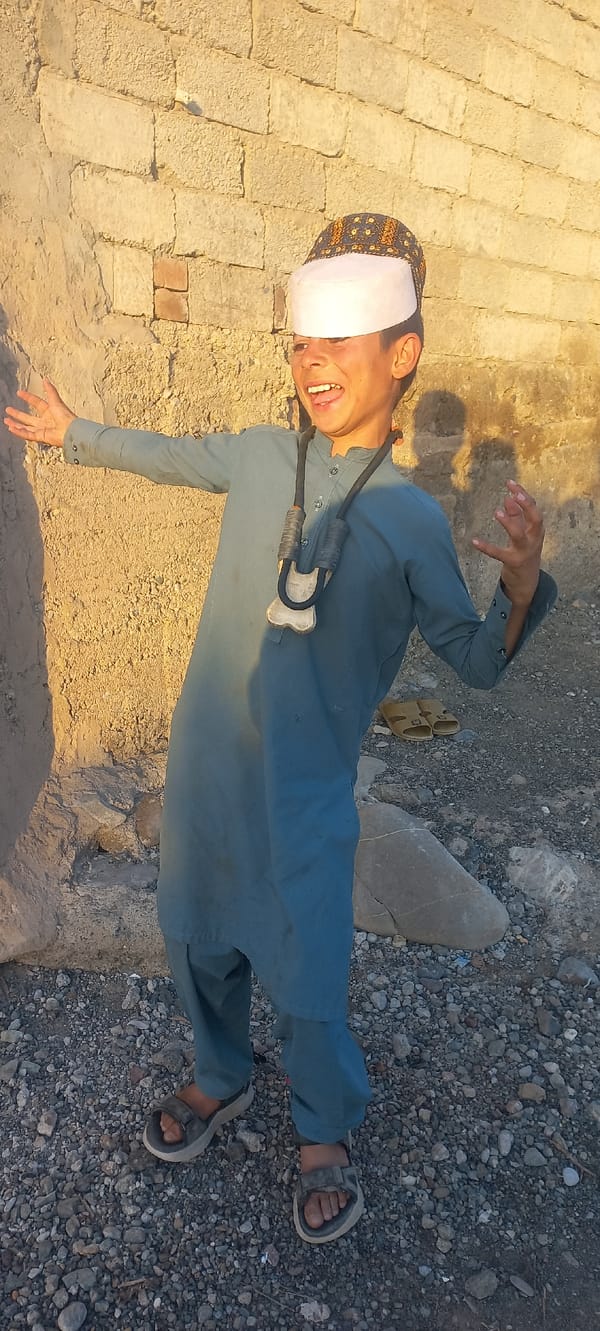 Two individuals in traditional and casual dress observed outdoors