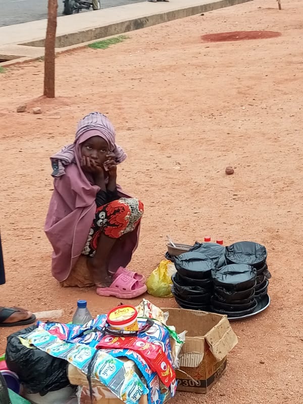 Morning hustle at a Gombe transit hub, vendors and travelers in motion