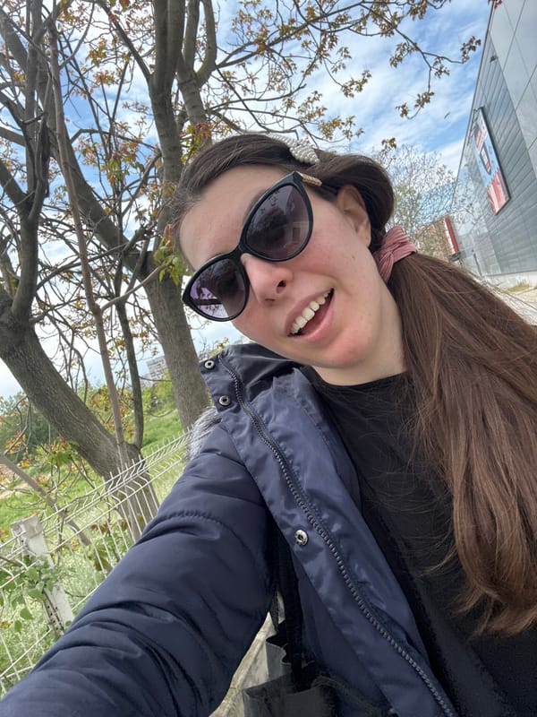 Woman takes selfie in city park amid spring blooms