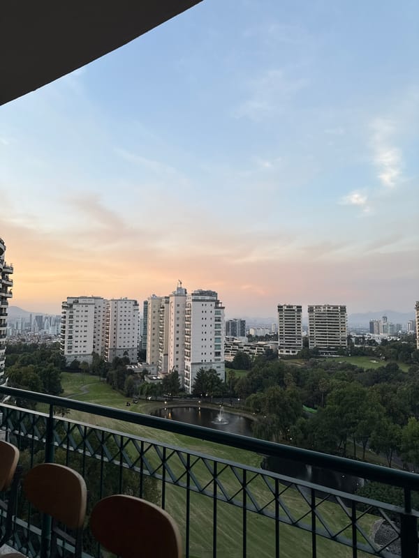 Golden hour cityscape view captured from Mexico City balcony