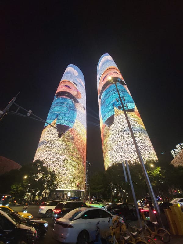 Chengdu's twin towers cycling through vivid LED facade displays at night