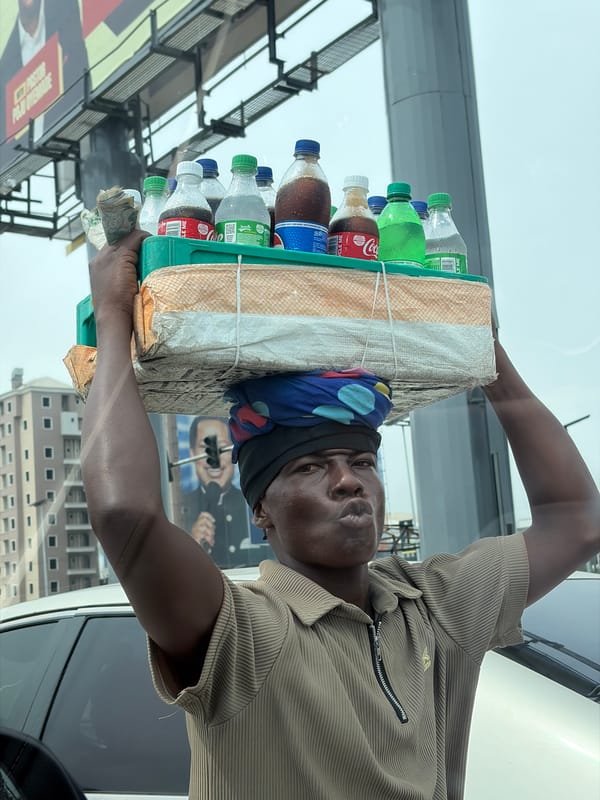 Street vendors sell drinks and fruit in Alaguntan, Nigeria