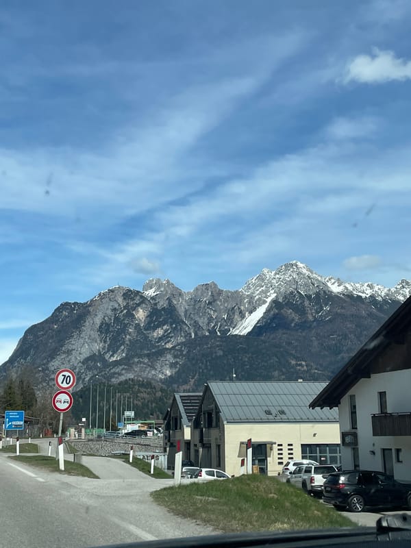 Vehicle travels scenic mountain route through Cadore region, Italy