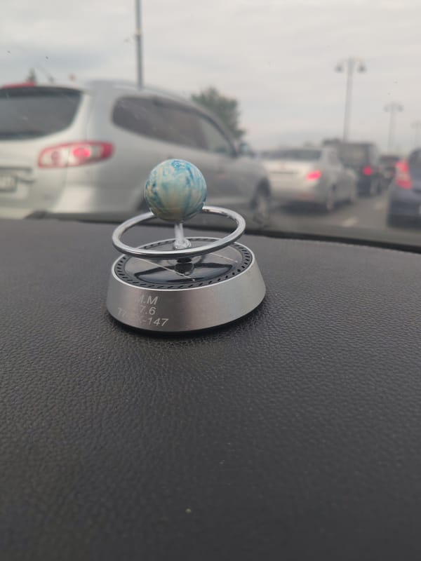 Kia interior with quirky dashboard decor, cruising Baku streets