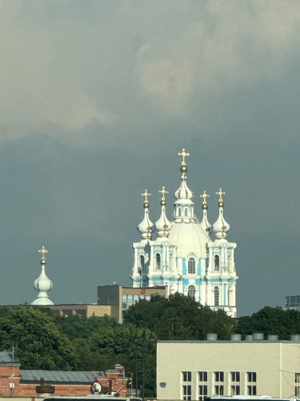 Historic domed church rises under cloudy Saint Petersburg skies