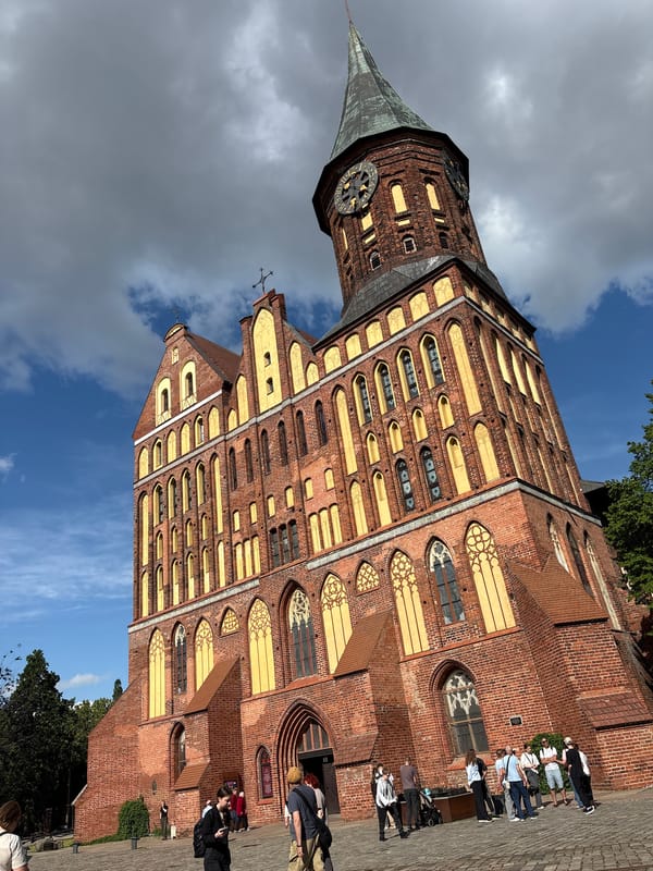 Sunny afternoon tourist activity documented at Kaliningrad historic waterfront
