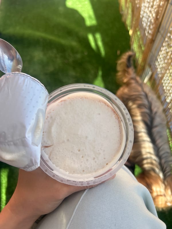 Person eats yogurt from plastic container in Burgas