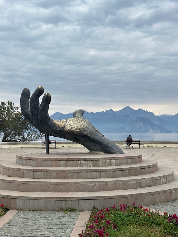 Morning scenes captured in Antalya: sculpture, cat, coastline