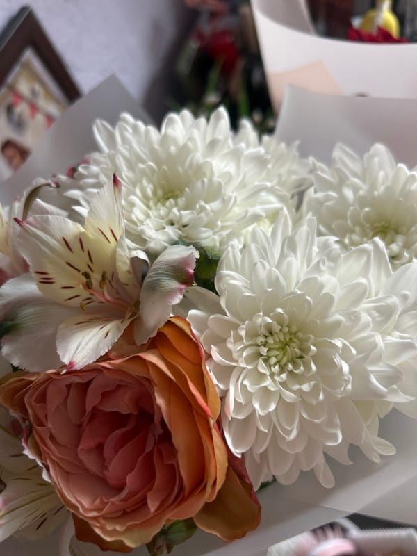 Quiet domestic moments: flowers, Easter basket, stuffed bear companion