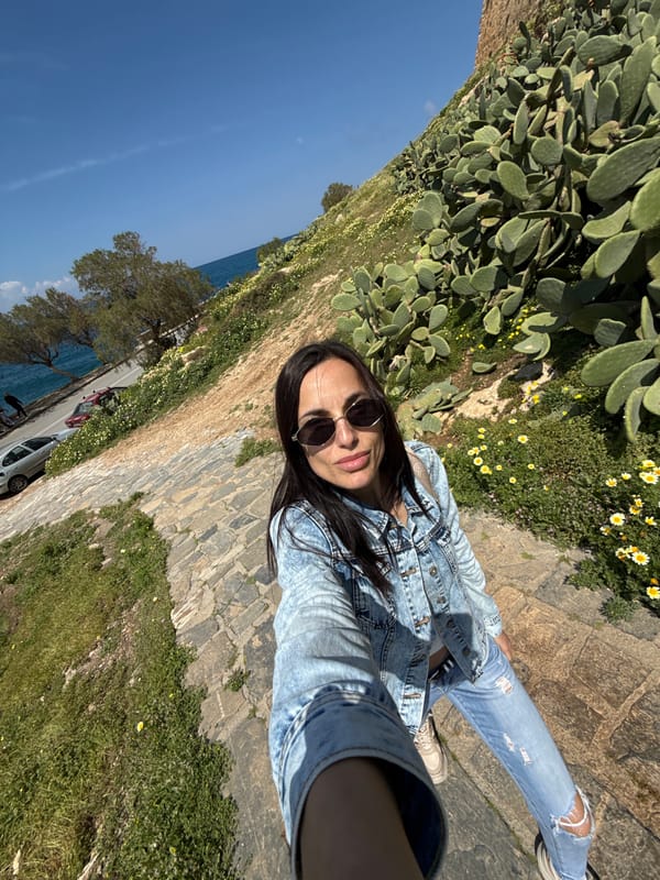 Tourist captures selfies during morning stroll in Rethymno, Greece
