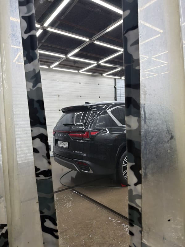 Auto repair shop workers service luxury vehicles in Krasnoyarsk