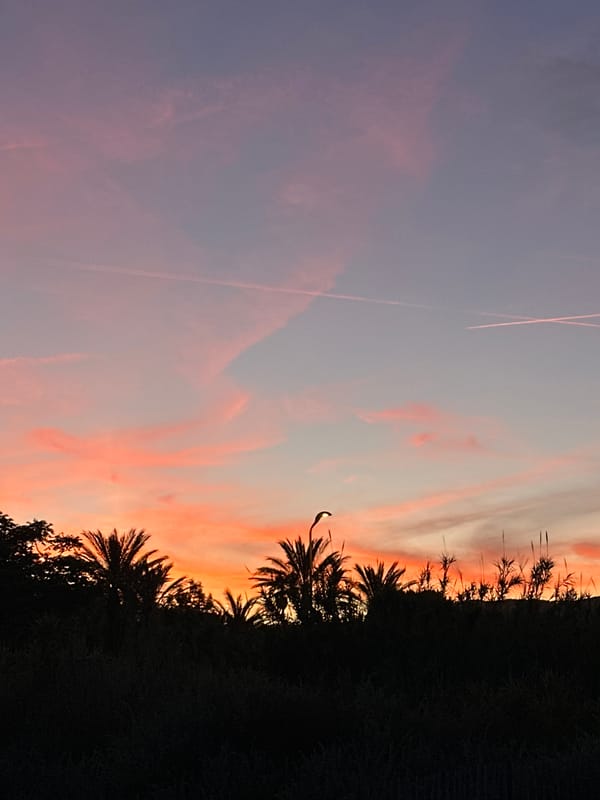 Sunset colors illuminate Le Lavandou coastline and lighthouse