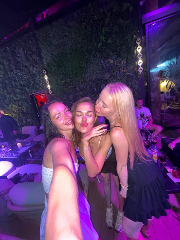 Three women take selfie at outdoor venue in Thailand