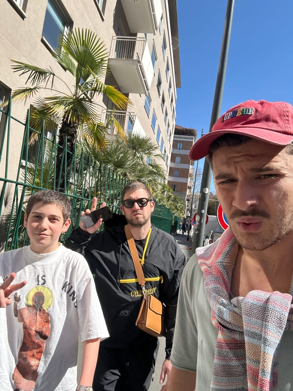 Three people pose for selfie on Milan street