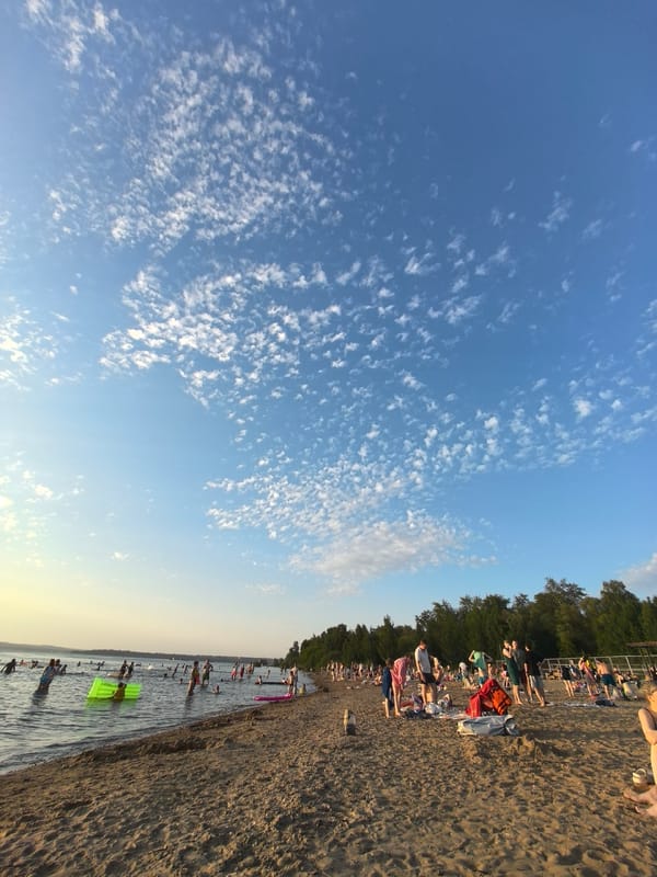 Summer afternoon on the Perm riverbank, sun and swimmers